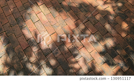 Tree shadows and sunlight on brick floor with copy space 130951117