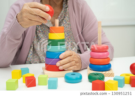 Asian elderly woman patient suffering from dementia learn practical motor skills rehabilitation. Asian elderly woman patient suffering from dementia learn practical motor skills rehabilitation. 130951251