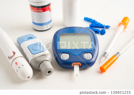 Glucometer lancet and test stick measuring human blood sugar level for diabetes. Glucometer lancet and test stick measuring human blood sugar level for diabetes. 130951255