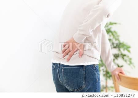 Middle women suffering from low back pain 130951277