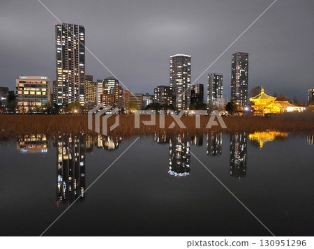 Skyscrapers reflected on the water, a daily night view Skyscrapers reflected on the water, a daily night view 130951296