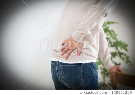 Middle women suffering from low back pain 130951299