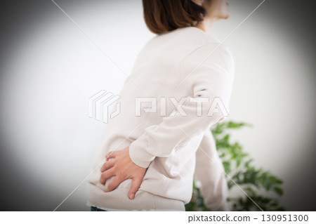 Middle women suffering from low back pain 130951300