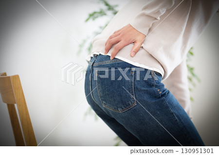 Middle women suffering from low back pain Middle women suffering from low back pain 130951301
