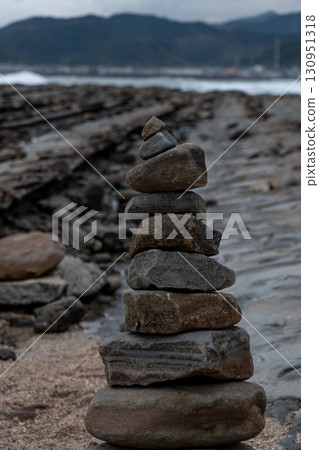 A stone tower standing on a quiet beach – Memories of Aoshima 130951318