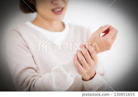 Middle woman suffering from wrist pain Middle woman suffering from wrist pain 130951655