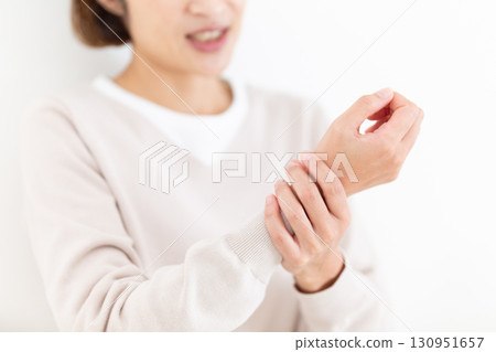 Middle woman suffering from wrist pain Middle woman suffering from wrist pain 130951657