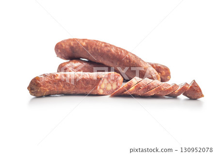 Sliced smoked sausage isolated on white background. 130952078