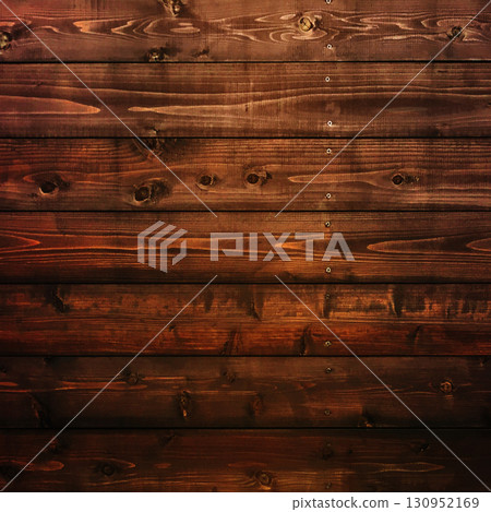 A square background image of dark brown boards with wood grain and knots nailed together horizontally 130952169