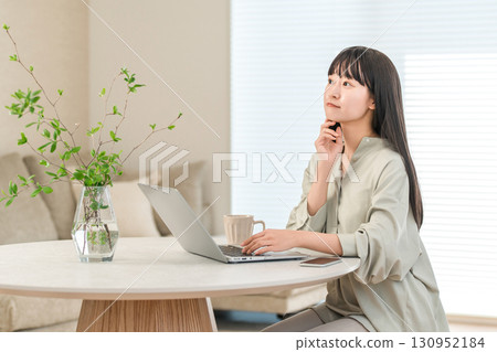 A troubled woman using a computer at home 130952184