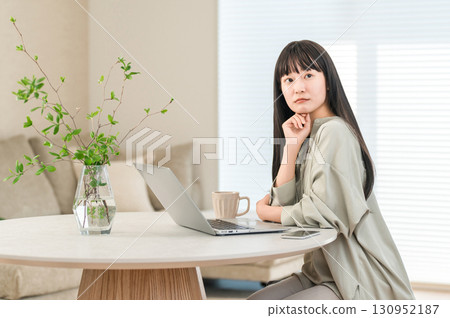 A troubled woman using a computer at home 130952187