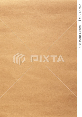 Vertical kraft brown paper sheet texture with visible creases Vertical kraft brown paper sheet texture with visible creases 130952202
