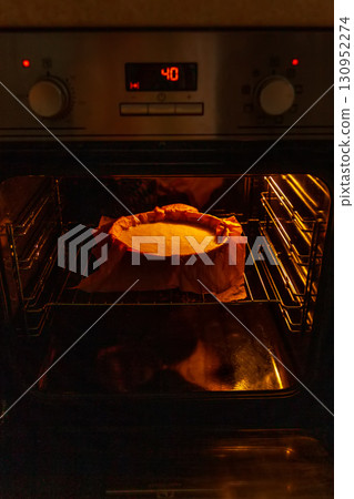 Cooking process homemade Basque burnt cheesecake. The form covered paper with the dough is in the oven and baked. Recipe step by step Cooking process homemade Basque burnt cheesecake. The form covered paper with the dough is in the oven and baked. Recipe step by step 130952274