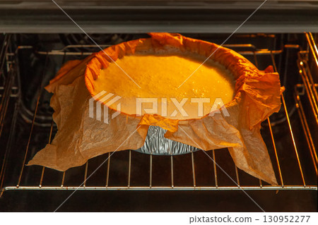 Cooking process homemade Basque burnt cheesecake. The form covered paper with the dough is in the oven and baked. Recipe step by step Cooking process homemade Basque burnt cheesecake. The form covered paper with the dough is in the oven and baked. Recipe step by step 130952277
