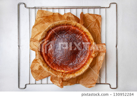 Homemade Basque burnt cheesecake immediately after baking on a rack Homemade Basque burnt cheesecake immediately after baking on a rack 130952284