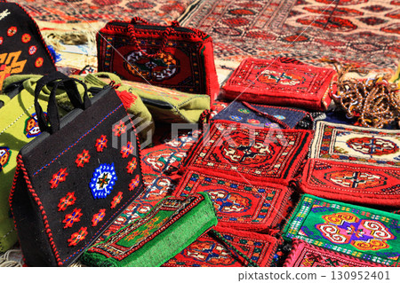 Handmade decorative bags and carpets with traditional ornament. Turkmenistan. Ashkhabad market. 130952401