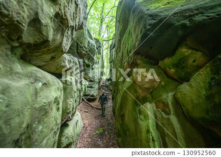 Beautiful green forest Hiking path with Sandstone chalk rock formations in Berdorf Mullerthal Luxembourg 130952560