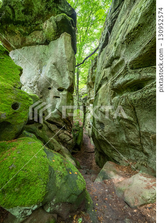 Beautiful green forest Hiking path with Sandstone chalk rock formations in Berdorf Mullerthal Luxembourg 130952574