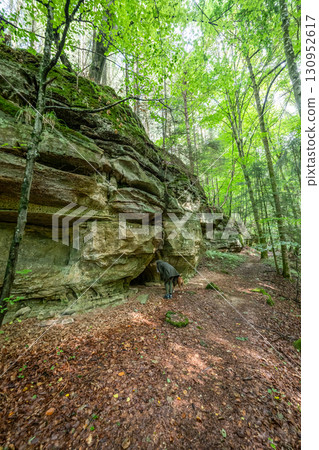 Beautiful green forest Hiking path with Sandstone chalk rock formations in Berdorf Mullerthal Luxembourg 130952617