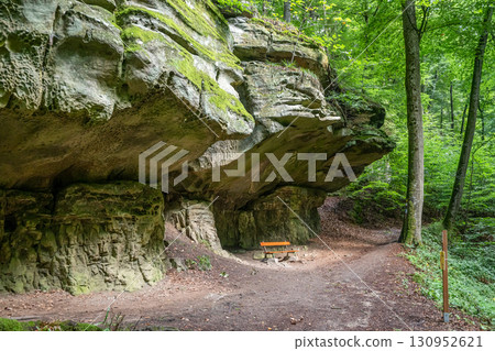 Beautiful green forest Hiking path with Sandstone chalk rock formations in Berdorf Mullerthal Luxembourg 130952621