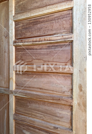 Rustic wooden door panel with natural grain texture 130952958