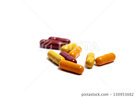 Pills. Tablets. Capsule. Heap of pills. Medical background. Close-up of pile of red white tablets - capsule. Pills and tablets.Blue background. 130953082
