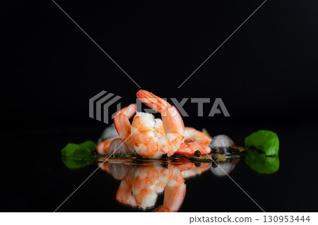 Appetizing shrimp with spices on a black background studio Appetizing shrimp with spices on a black background studio 130953444