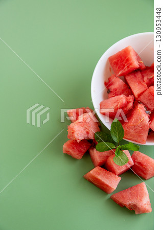 bright watermelon slices in bowl and on surface bright watermelon slices in bowl and on surface 130953448