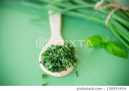 Dried and fresh green onions on green background from above 130953454