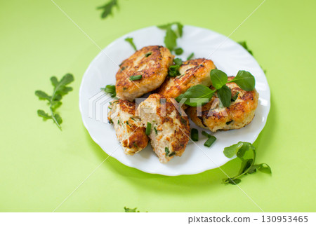 Chicken cutlets fried until crisp isolated on a green background Chicken cutlets fried until crisp isolated on a green background 130953465
