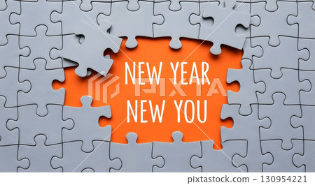 New year, new you concept shown with puzzle pieces against an orange backdrop. New year, new you concept shown with puzzle pieces against an orange backdrop. 130954221