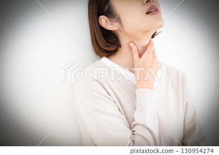 Middle-aged woman suffering from sore throat Middle-aged woman suffering from sore throat 130954274