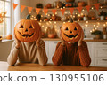 Festive Halloween scene at home with carved jack o lantern pumpkins held in front of faces 130955106