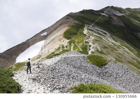 A man walking along the ridge of the Northern Alps 130955666