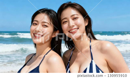 Two Japanese women in swimsuits playing in the sea Two Japanese women in swimsuits playing in the sea 130955910