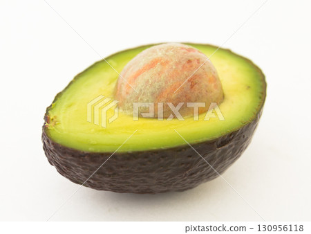 halved avocado with bone on white background halved avocado with bone on white background 130956118