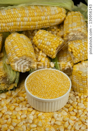 Fresh Corn Cobs with Raw Corn Grits in Bowl 130956143