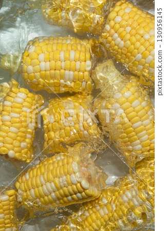 Splashing Fresh Corn Cobs in Water Closeup. 130956145