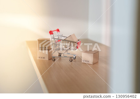 Shopping Cart. Miniature shopping cart with boxes representing online purchases. 130956402
