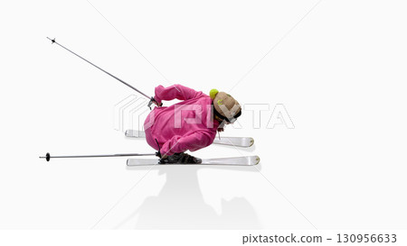 Skier in pink hoodie leaning into sharp carve turn with playful intensity Skier in pink hoodie leaning into sharp carve turn with playful intensity 130956633