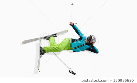 Female skier lying on snow after fall with expressive gesture isolated on white 130956680