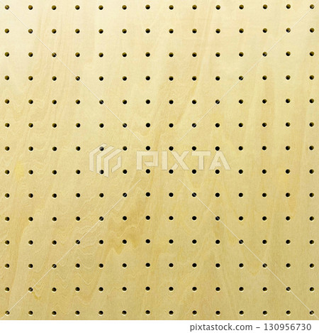 Background image of a square light yellow pegboard with wood grain 130956730