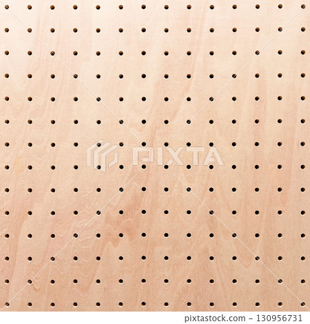 Background image of a square light reddish-brown perforated board with wood grain Background image of a square light reddish-brown perforated board with wood grain 130956731