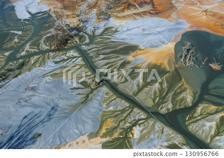 Aerial view of surreal natural patterns of gold cyanide leaching flowing into decanting lake Aerial view of surreal natural patterns of gold cyanide leaching flowing into decanting lake 130956766