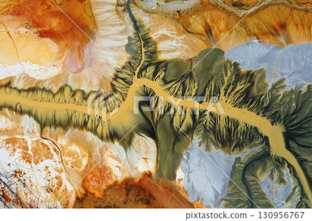 Aerial view of surreal natural patterns of gold cyanide leaching flowing into decanting lake 130956767