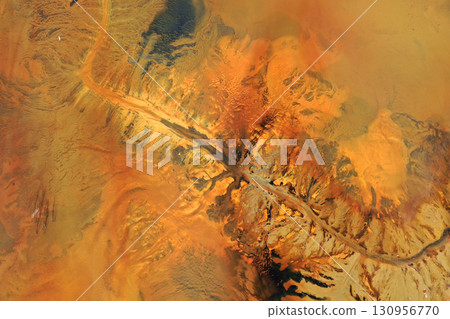 Aerial view of surreal natural patterns of gold cyanide leaching flowing into decanting lake Aerial view of surreal natural patterns of gold cyanide leaching flowing into decanting lake 130956770