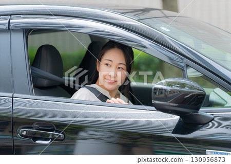 A woman driving a car 130956873