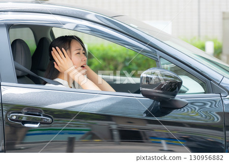 Woman driving a car panic 130956882