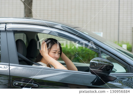 Woman driving a car panic 130956884