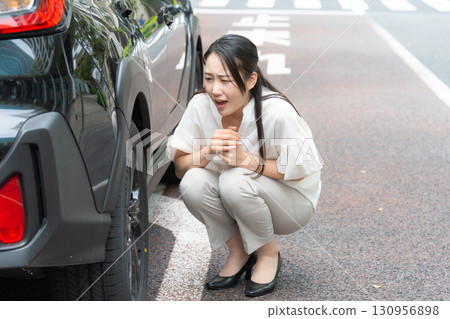 Woman checking a car 130956898
